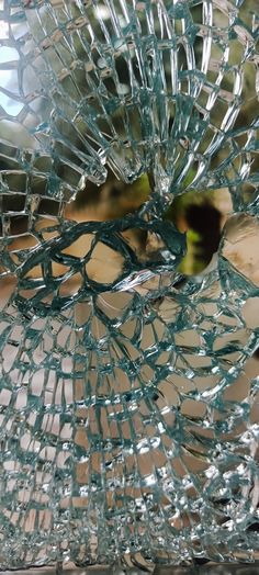 a broken glass vase sitting on top of a table