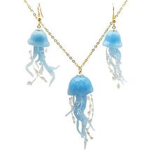 two blue jellyfish necklaces on a gold chain