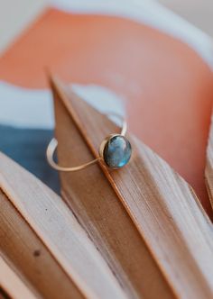 Our Dori ring is made with a gorgeous Labradorite stone. This mystical gemstone is believed to enhance mental clarity and bring about transformation. It's a crystal connected to the third eye chakra which is our gateway to inner wisdom and deeper intuition. 8mm round or 6x8mm oval labradorite stone. Ring band measures 1mm wide. Available in 14kt Gold Fill + Sterling Silver. KJ pairs it with our Sonder Ring, Raye Ring, and Confetti Ring. Handmade in Eau Claire, WI. Our jewelry is handmade so each Elegant Labradorite Crystal Ring As Gift, Unique Round Labradorite Jewelry, Spiritual Gold Labradorite Rings, Confetti Ring, Bohemian Round Labradorite Crystal Ring, Handmade Labradorite Spiritual Rings, Copper Uses, Everyday Wear Jewelry, The Third Eye