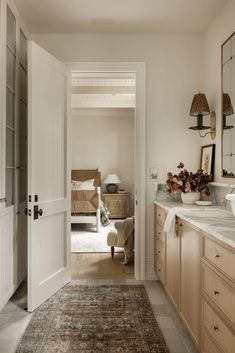 a hallway leading to a bedroom and bathroom