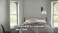 a bedroom with three windows and a bed in the corner that reads, acacia haze by shewin williams