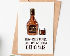 a card with an image of a bottle of whiskey and a glass next to it