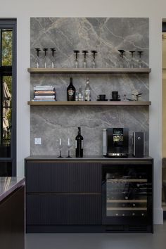 a bar with wine glasses and bottles on it