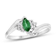 A marvelous choice for day or night, this charming gemstone and diamond ring makes creating a chic look easy. Crafted in 14K white gold, this graceful style features a rich 6.0 x 3.0mm marquise-cut verdant-green emerald. Trios of sparkling diamonds flank the center stone while the sculpted double ribbons of the shank bypass around the center. Radiant with 1/20 ct. t.w. of diamonds and a brilliant buffed luster, this ring gleams with exquisite design. Diamond May Birthstone Ring With Center Stone, Diamond Birthstone Ring With Center Stone For May, Formal Birthstone Ring In Diamond White With Accent Stones, Formal Diamond White Birthstone Ring With Accent Stones, Classic Diamond Ring With Accent Stones For May Birthstone, Fine Jewelry Marquise Cut Emerald Ring With Diamond Accents, Diamond Cluster Ring With May Birthstone, Marquise Cut Emerald Ring With Diamond Accents, Formal Diamond Ring With Prong Setting For May Birthstone