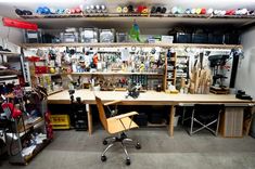 a room filled with lots of different types of tools and accessories on shelves above a desk