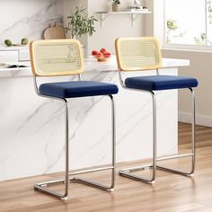 two chairs sitting next to each other on top of a hard wood floored floor