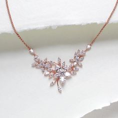 This floral rose gold necklace will add an elegant touch to any bridal look.  - Handcrafted with Premium Cubic Zirconia stones. - All clear stones - Rhodium, yellow gold or rose gold finish - Necklace measures 16 inches and extends to 18 inches - Nickel free and hypoallergenic - PLEASE ALLOW APPROX 3-5 BUSINESS DAYS FOR COMPLETION BEFORE SHIPPING. If you would like a backdrop added click here: https://www.etsy.com/listing/601882345/bridal-backdrop-back-drop-addition-add-a?ref=shop_home_active_19 Delicate Rose Gold Diamond Necklace For Wedding, Delicate Rose Gold Cubic Zirconia Bridal Necklace, Delicate Rose Gold Cubic Zirconia Necklace, Rose Gold Cubic Zirconia Bridal Necklace For Anniversary, Rose Gold Cubic Zirconia Diamond Necklace For Wedding, Rose Gold Cubic Zirconia Necklace With Flower Pendant, Elegant Rose Gold Necklace For Mother Of The Bride, Rose Gold Necklaces With Cubic Zirconia Flower Pendant, Delicate Rose Gold Bridal Necklace For Formal Occasions