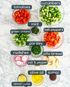 the ingredients to make this salad are shown in bowls on a marble counter top, including carrots, cucumbers, bell peppers, parsley, onions, pita bread and olive oil