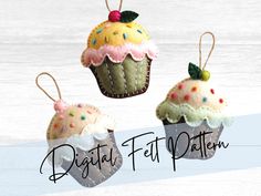 three felt cupcakes hanging from strings on a white wooden background with the words digital felt patterns