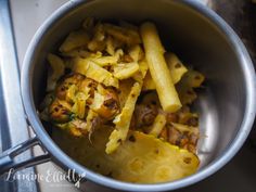 a pot filled with pasta and vegetables on top of a stove