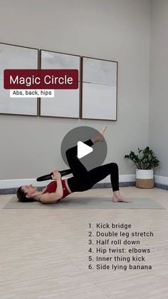 a woman is doing yoga on the floor in front of a wall with three pictures