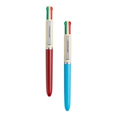 two pens sitting next to each other on top of a white surface with red and blue tips