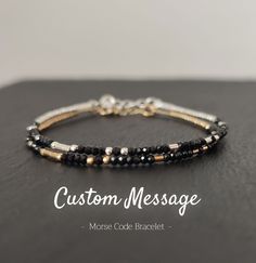 This is a minimalist, hidden message Morse Code bracelet. It is made of shimmering faceted Black Tourmaline gemstone beads (AAA quality) and either Sterling Silver or 18K Gold Filled beads. The first photo shows both options together. This listing is for one bracelet. Please select your preferred metal material. The lobster clasp and other components are made of Sterling Silver or 18K Gold Fill.  The beads are strung on the finest quality silver beading wire for maximum strength and suppleness, Modern Black Jewelry For Friendship, Minimalist Personalized Beaded Bracelets, Modern Black Bracelet As A Gift, Modern Black Bracelets For Friendship, Minimalist Adjustable Black Name Bracelet, Black Minimalist Name Bracelet As Gift, Black Minimalist Name Bracelet For Gift, Minimalist Black Name Bracelet Gift, Minimalist Black Name Bracelet