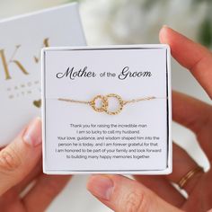 the mother of the groom bracelet is in its gift box and it's being held by someone