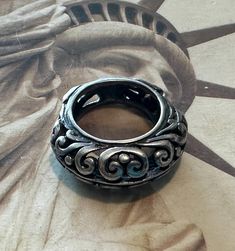 This sale is for a vintage Sterling Silver Ring with a very unique shape. It's a size 6 1/4 and weighs 7.9 grams. The ring pictured is the ring you will receive. It does have some patina on it that I will leave or can clean and shine at the buyers request. Antique Engraved Open Metal Ring, Vintage Sterling Silver Engraved Dome Ring, Vintage Engraved Sterling Silver Dome Ring, Handmade Antique Silver Vintage Rings, Handmade Vintage Antique Silver Rings, Round Metal Wide Band Promise Ring, Vintage Metal Engraved Ring For Gift, Handmade Victorian Metal Rings, Vintage Engraved Metal Ring As Gift