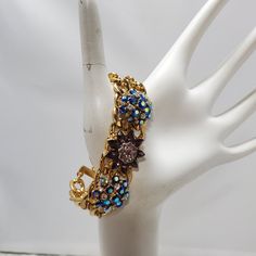 Embrace A Burst Of Vibrant Elegance With This Multi-Color Rhinestone With Gold Links Bracelet. The Bracelet Features A Dazzling Array Of Rhinestones In A Spectrum Of Colors, Each Intricately Set Within Chic Gold Links. Measuring A Graceful 7.5 Inches In Length, This Bracelet Gracefully Adorns Your Wrist With A Delightful Blend Of Glamour And Playfulness. The Gold Links Add A Touch Of Sophistication To The Vibrant Hues, Creating A Versatile Accessory Suitable For Various Occasions. Illuminate You Blue Crystal Bracelet For Party, Blue Crystal Bracelet With Rhinestones For Party, Blue Rhinestone Crystal Bracelet For Party, Blue Jeweled Bracelets For Party, Vintage Blue Bracelets For Party, Blue Jeweled Party Bracelets, Gold Link Bracelet, Gold Jewelry Fashion, Jewelry Gold