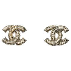 A pair of Chanel CC Pearl Earrings. The quintessential style statement. Pearls and crystals adorn the most iconic logo in the world for a demure look. Who wouldn’t want to own a piece of vintage Chanel jewellery? A major part of her eponymous House since 1923 Gabrielle Chanel’s jewel legacy is unparalleled. A passionate innovator and champion of ‘bijoux de couture’ or ‘costume jewellery’, Gabrielle made ‘faux’ de rigeur in high society, taking wearable art stratospheric. The world and almost every fashion house following suit, captivated by her inimitable, timeless jewel style. Following Gabrielle’s passing, her jewel legacy entered a new mega-watt era with Karl Lagerfeld and Victoire de Castellane designing Chanel costume jewellery from the early ‘80s. Their collections immortalised the i Chanel Earrings Diamond, Chanel Pearl Drop Earrings, Luxury Channel-set Diamond Earrings, Chanel Earrings Dangle, Channel Earrings, Chanel Costume Jewelry, Vintage Chanel Jewelry, Chanel Pearl, Victoire De Castellane