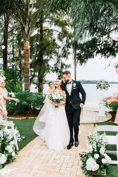 a bride and groom walking down the aisle