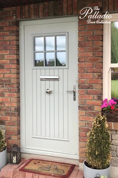 a white front door with two potted plants on either side and the words pellatto above it