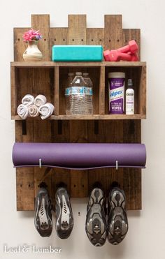 there is a purple mat and some pairs of shoes on the shelf next to it