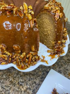 a bundt cake with pecans and caramel toppings