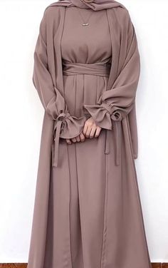 Three Pc Modest Wear Set.Includes belted inner. Outer coat. Hijab.A beautiful simple & elegant abaya... Elegant Abaya With Kimono Sleeves For Eid, Elegant Solid Abaya For Fall, Elegant Solid Color Abaya For Fall, Eid Elegant Abaya With Kimono Sleeves, Eid Abaya With Kimono Sleeves And Elegant Style, Elegant Belted Abaya, Elegant Long Winter Abaya, Chic Long Abaya For Eid, Elegant Long Sleeve Brown Abaya