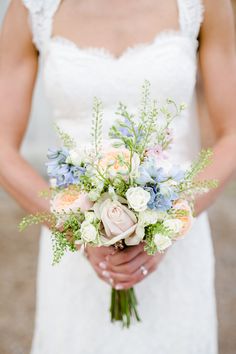 a woman holding a bouquet of flowers in her hands