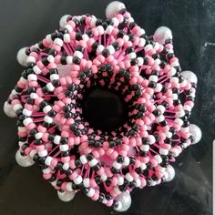 a pink, black and white beaded wreath