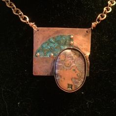 Living in an area plagued by fires, this piece represents things salvaged from the ruins.  The copper has been deliberately strategically melted and has an aging patina. The polymer mokume-gane piece sits in a copper bezel.  The small slice on verdigris-pantinad copper is riveted to the base. It hangs on a copper chain. Artistic Copper Jewelry, Artsy Electroformed Jewelry For Gifts, Patina Round Pendant Necklace For Gift, Patina Round Pendant Necklaces For Gift, One Of A Kind Artsy Pendant Jewelry, Round Pendant Necklace With Patina For Gift, One-of-a-kind Artsy Pendant Jewelry, Artsy One-of-a-kind Pendant Jewelry, Unique Patina Round Pendant Necklace