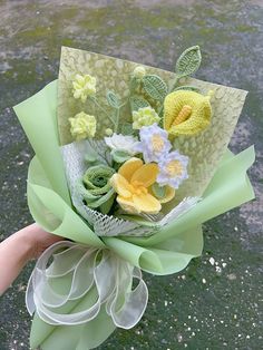 a person holding a bouquet of flowers in their hand