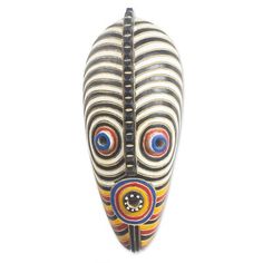 an african mask with multicolored lines and circles on it's face, against a white background