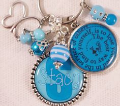 a keychain with some charms on it that says stay and is attached to a chain