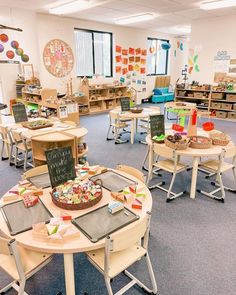 a classroom filled with lots of tables and chairs