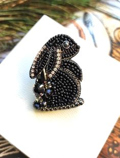 Beautiful and impressive, handcrafted rabbit brooch.This embroidered jewelry will perfectly complement your jewelry collection or will be a wonderful gift to a very special person.Handembroidered rabbit with glass beads, chrystal's, Czech beads, metal thread. Looks very beautiful.– – – – – – – – – – – – – – – – – – – – – – – – – – – – – – – – – – – – – – – – – – – – – – – – –If you can't find exactly what you want, please contact me and I will make unique, one of a kind jewelry based on your wis Insect Jewelry Diy, Beaded Brooch Diy, Beaded Penguin, Beaded Rabbit, Embroidery Rabbit, Rabbit Brooch, Beaded Pins, Embroidered Brooches, Beaded Flowers Patterns