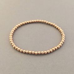 "14k gold fill, rose gold fill, or sterling silver balls are strung onto a stretchy elastic cord. Balls measure 3 mm (approximately 1/8 of an inch). Available as a single bracelet or a set of 3. Great piece to layer! 4mm ball bracelet is here: https://www.etsy.com/listing/694393921/4mm-beaded-ball-bracelet-in-gold-fill 5mm ball bracelet is here: https://www.etsy.com/listing/694396085/5mm-beaded-ball-bracelet-in-gold-fill YOUR ORDER - Choose the number of bracelets you want in the drop-down menu, Rose Gold Stackable Stretch Bracelet With Round Beads, Rose Gold Stackable Bracelet With Round Beads, Stackable Round Beads Bracelets In Rose Gold, Stackable Rose Gold Beaded Bracelets, Rose Gold Stackable Beaded Bracelets, Dainty Rose Gold Bracelets With Round Beads, Minimalist Rose Gold Bracelets With Round Beads, Everyday Rose Gold Round Beaded Bracelets, Everyday Rose Gold Beaded Bracelets