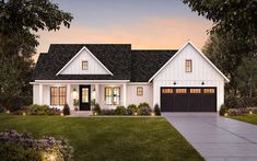 a white house with black shutters and two garage doors on the side of it