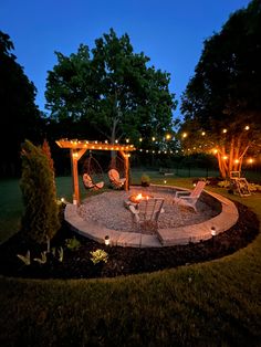 an outdoor fire pit surrounded by lawn chairs and string lights at night with patio furniture in the foreground