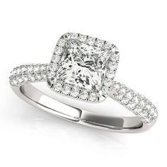 a cushion cut diamond engagement ring with pave set shoulders