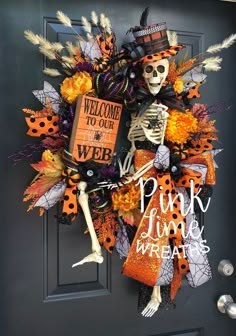 a wreath decorated with skeletons and pumpkins on the front door to welcome guests for halloween