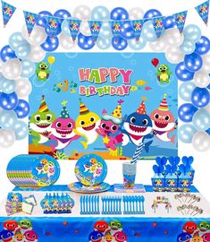 a birthday party set up with shark decorations and blue table cloths, balloons and streamers