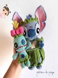 two crocheted stuffed animals sitting on top of each other in the palm of someone's hand