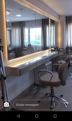 a hair salon with chairs, mirrors and lights