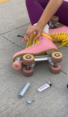 a skateboard that is laying on the ground next to some screws and nails