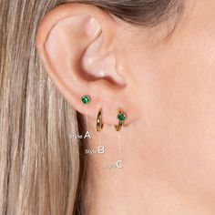 Overview: This earring set features a contemporary mix of styles: Huggie hoop and stud earrings, crafted from 14k gold. The hoop and stud earrings boast lab-created emerald gemstones, making them a perfect choice for those born in May (emerald birthstone). The versatile design allows for wear in multiple piercings including lobe, conch, cartilage, helix, and tragus, making this set ideal for everyday accessorizing or creating a trendy, curated ear look. This captivating earring set features the Modern Small Hoop Piercings As A Gift, Everyday Yellow Gold Huggie Earrings With Birthstone, Modern Huggie Piercings As Gift, Modern Huggie Piercings For Gift, Modern 14k Gold Piercings As A Gift, May Birthstone Round Hoop Earrings For Pierced Ears, Minimalist Hoop Earrings With Birthstone, May Birthstone Round Hoop Earrings, Modern Gold Earrings For May Birthstone