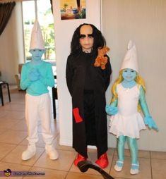 three people dressed up in costumes standing next to each other on the tile flooring