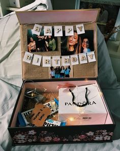 an open suitcase filled with personalized items and pictures on the inside, sitting on a bed