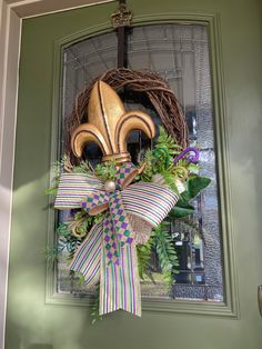 a front door with a wreath and mask on it