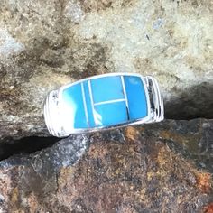 This beautiful Sterling Silver Ring, as part of the Arizona Blue Collection, features Kingman Turquoise. Ring Width: 3/8"; Ring Shank: 3/16" The ring is designed by David Rosales, one of the finest contemporary Southwest Artists in the world. He is the founder and co-owner of Supersmiths, Inc. of Gallup, NM. Each ring is custom made and carries a lifetime guarantee. Modern Blue Turquoise Gemstone Ring, Modern Blue Sterling Silver Ring, Modern Sterling Silver Blue Ring, Modern Blue Open Ring, Modern Blue Gemstone Rings, Blue Oval Rings With Inlay, Blue Turquoise Ring With Inlay, Blue Turquoise Open Ring With Gemstone, Blue Inlay Rings For Anniversary