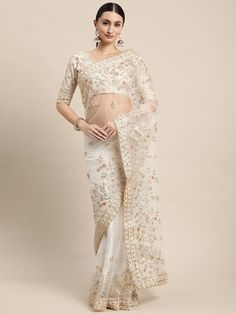 Product Description: Introducing our exquisite White Color Pure Soft Net Saree with intricate floral work. This beautifully crafted saree is made from imported sequence soft net fabric, ensuring a luxurious and comfortable feel. The saree comes with an unstitched blouse piece made from high-quality Banglori Silk. Both the saree and blouse showcase stunning embroidery work, adding a touch of elegance and glamour to any occasion. Highlights: - Handmade - Ships from a small business in India - Gift wrapping available Product Details: - Fabric: Soft Net - Length: 5.5 meters - Border: Lace - Blouse Fabric: Banglori Silk - Blouse: Separate unstitched blouse piece - Trends: Celebrity Saree Benefits: - The soft net fabric offers a lightweight and flowy feel, perfect for comfort throughout the day. Saree Embroidery Work, Off White Saree, Saree Party Wear, Sequence Saree, Sequence Blouse, Saree Embroidery, Floral Work, Back Neck Designs, White Saree