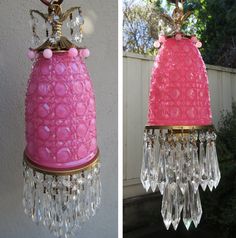 a pink lamp hanging from the side of a wall next to another light fixture with crystal drops on it